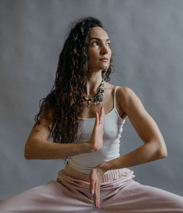 Woman in a graceful yoga pose, illustrating body harmony and balance.